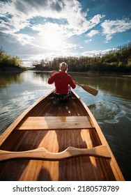 Woman Paddling Canoe On The Lake