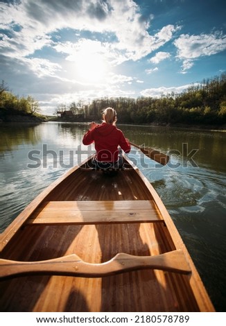 Woman paddling canoe on the lake