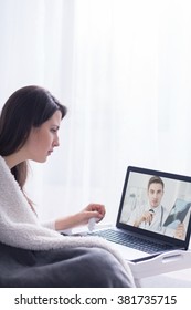 Woman With Pain Sitting On Bed And Skype Doctor Holding X-ray Picture