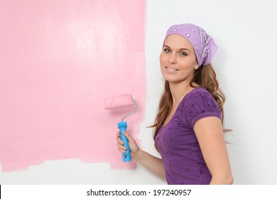 Woman Painting Baby Nursery Pink