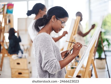 Woman, painting and easel canvas in art class or creativity workshop with learning, watercolor or relaxing. Female person, student and paintbrush or hobby process for relax project, craft or artist - Powered by Shutterstock