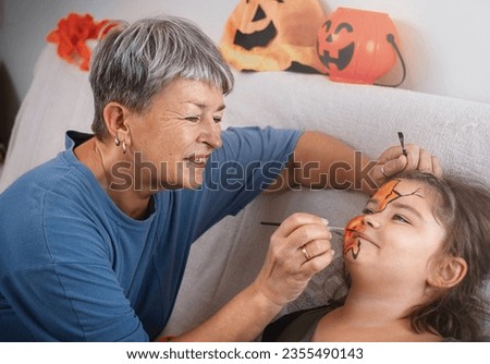 Woman painting face art to child for halloween