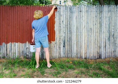 Woman Painting Fence