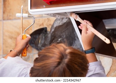 Woman Painting Furniture To Restore In Old Patio With Flowerpots And Whitewashed Walls ,  , Selective Focus