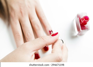 Woman Painting Her Nails With Red Nail Polish