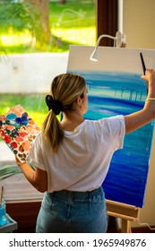 Woman Painting On Easel Taking A Virtual Class