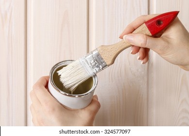 Woman Painting Wood