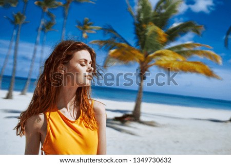 Woman palm Sand yellow swimsuit tropics