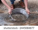 Woman panning for gold with a prospector