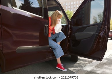 Woman With Paper Bag Suffering From Nausea In Car