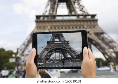 Woman In Paris Taking Pictures In Front Of Eiffel Tower With Her Tablet PC