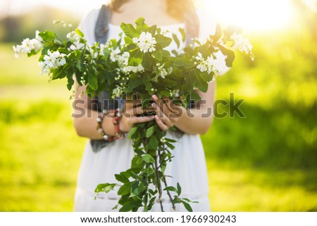 Similar – Woman making wild flowers at home in vase