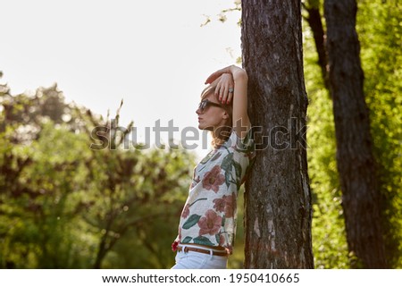 Similar – Woman with sunglasses raising her arms over nature background