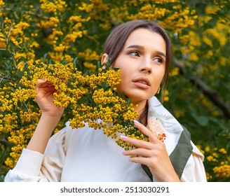 woman in park posing with melon,holding fruit on eyes or below waist.girl with picnic accessories, autumn fruit as strawberry.female drinking tea,pouring from vintage kettle.bush with yellow berries. - Powered by Shutterstock