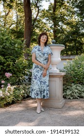 Woman In Park.. Senior Working In Garden. Close-up Portrait Of An Older Woman On Walk With Flowers. Park.