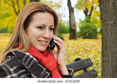 Woman in Park talking on a mobile phone