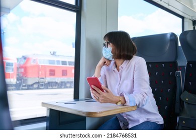 Woman Passenger In Medical Face Mask Is Sitting Inside Train