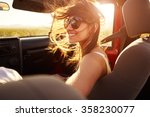 Woman Passenger On Road Trip In Convertible Car