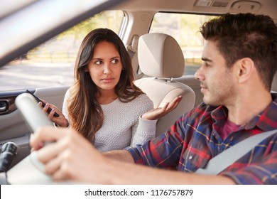 Woman Passenger With Smartphone Talking To Driver In Car