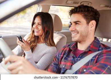 Woman passenger using GPS on smartphone during car journey - Powered by Shutterstock