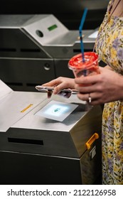 Woman Passing Through Turnstile In Underground