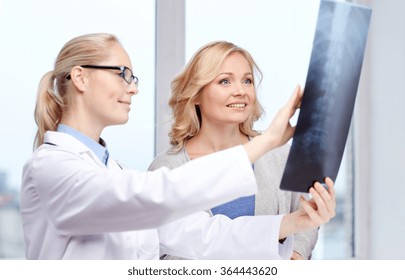 Woman Patient And Doctor With Spine X-ray Scan