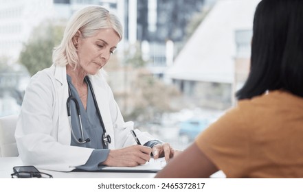 Woman, patient and doctor writing on document for treatment plan form, physical examination paper and consent report. Mature, female medical worker and consulting with insurance, referral and notes. - Powered by Shutterstock