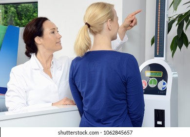 Woman as a patient in pharmacy or doctor's office measures weight and body fat on scales - Powered by Shutterstock