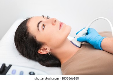 Woman Patient Receives Thyroid Diagnostics. Treatment Of Thyrotoxicosis, And Hypothyroidism. Ultrasound Diagnostics Of The Endocrine System And Thyroid