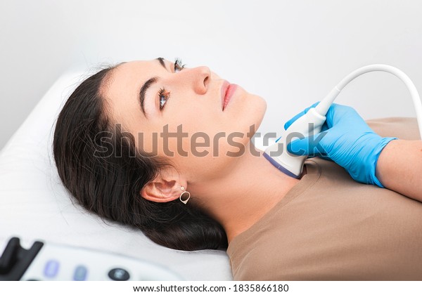 Woman patient receives thyroid diagnostics.\
Treatment of thyrotoxicosis, and hypothyroidism. Ultrasound\
diagnostics of the endocrine system and\
thyroid