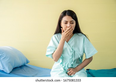 Woman Patient Suffering From Stomach Ache And Nausea While Sitting On Bed At Hospital, Abdominal Pain, Food Poisoning