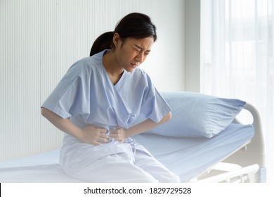 Woman Patient Touching Stomach Painful Suffering From Stomachache Causes Of Menstruation Period, Gastric Ulcer Or Gastrointestinal System Disease. Healthcare And Medical Concept.