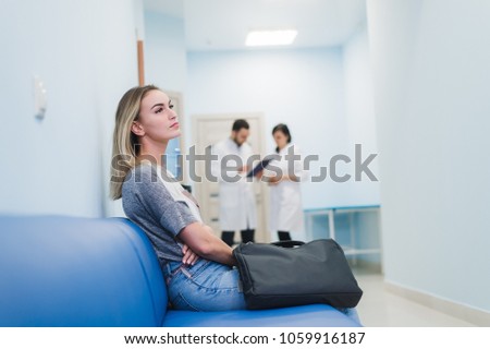Woman patient waiting at hospital Doctors Waiting Room