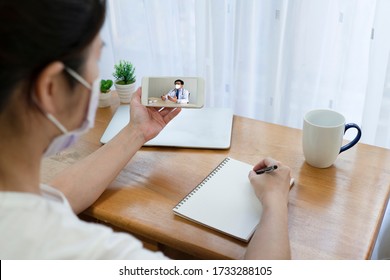 woman patient who got fever and cough suspected of covid-19 or coronavirus infection consult asian doctor via video call. telemedicine and new normal lifestyle concept - Powered by Shutterstock