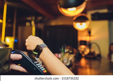 Woman pay by smart watch with NFC technology. - Powered by Shutterstock