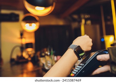 Woman pay by smart watch with NFC technology - Powered by Shutterstock