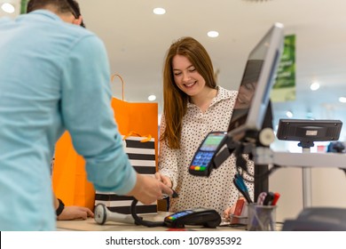 Woman Paying For Apparel In Store