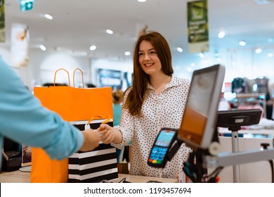 Woman Paying For Apparel In Store