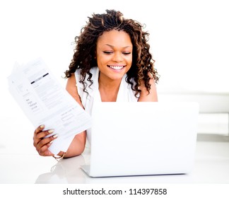 Woman Paying Bills Online From Home And Smiling