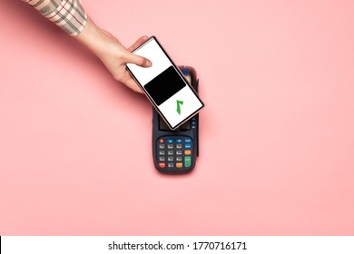 Woman Paying By Card On NFC Payment Contactless Terminal