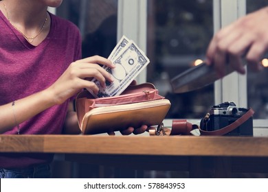 Woman Paying Cash For Bill Restaurant