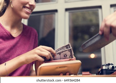 Woman Paying Cash For Bill Restaurant