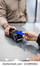 Woman Paying Contactless With Credit Card In A Shop