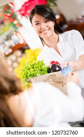 Woman Paying With A Credit Card At The Checkout