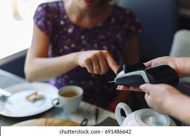 Woman Paying His Bill In Restaurant, Using Credit Card