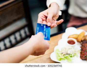 Woman Paying Lunch With Credit Card At Restaurant