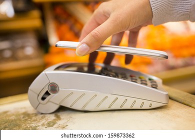 Woman Paying With Nfc Technology On Mobile Phone In Supermarket, Electronic Reader 