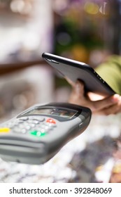 Woman Paying With NFC Technology On Celphone