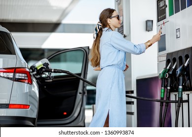 Woman Paying With Phone For Gasoline, Photographing Bar Code On The Gas Station Pump