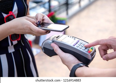 Woman Payment Via Credit Card Swipe Machine.